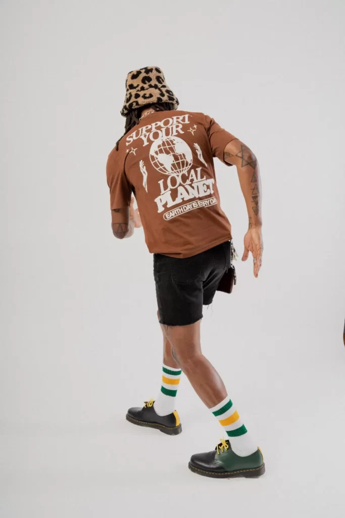 Model wearing new york clothing brand CHNGE t shirt which says support your local planet