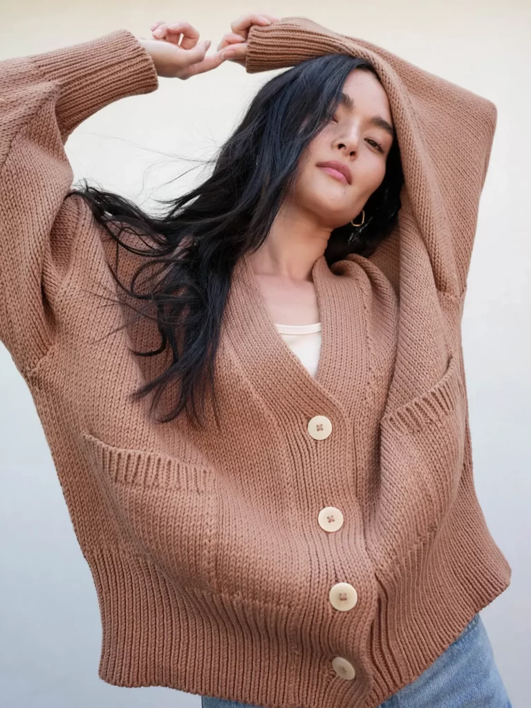 A woman wearing a brown made in usa cardigan by MATE