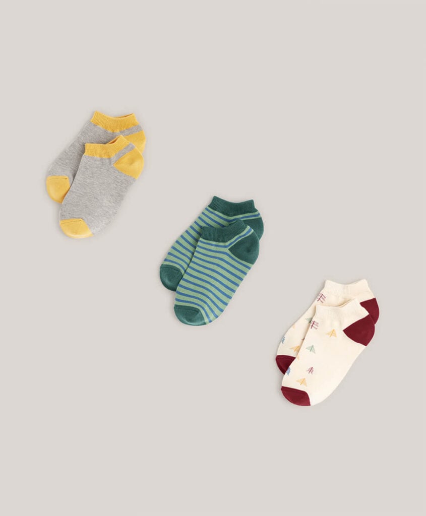 Pact Organic kids ankle socks in three patterns; block color, stripe, and trees