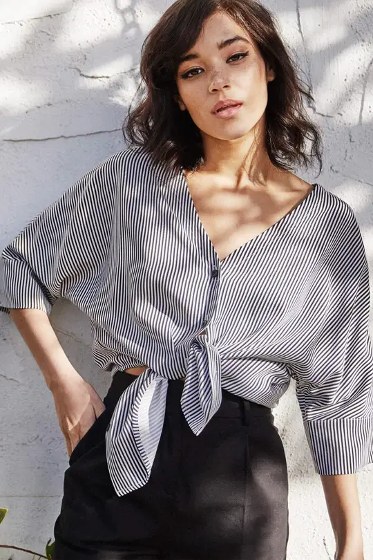 A woman wearing a blue blouse